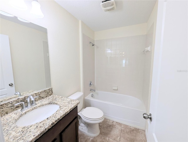 full bathroom with vanity, tiled shower / bath combo, a textured ceiling, and toilet