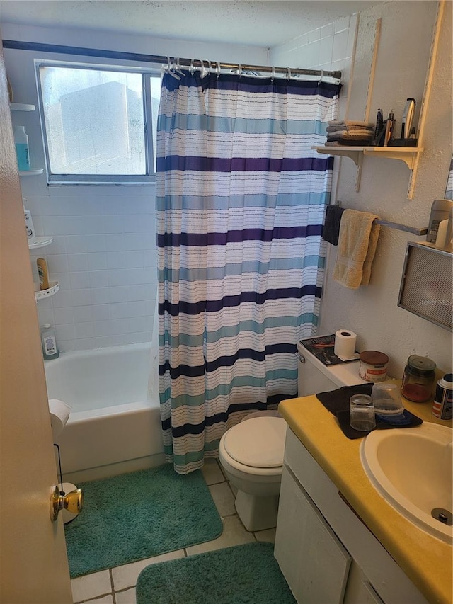 full bathroom with tile patterned floors, shower / bath combo with shower curtain, vanity, and toilet