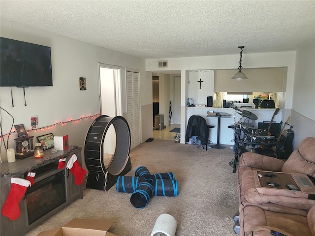 carpeted living room with a textured ceiling