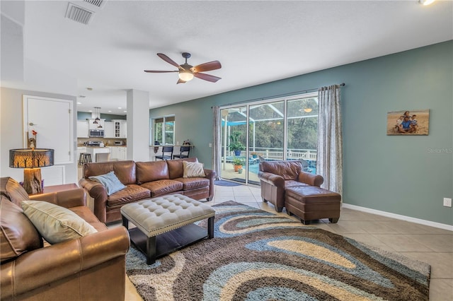 tiled living room with ceiling fan