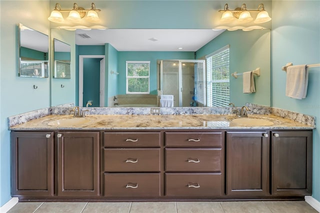 bathroom with tile patterned floors, vanity, and walk in shower