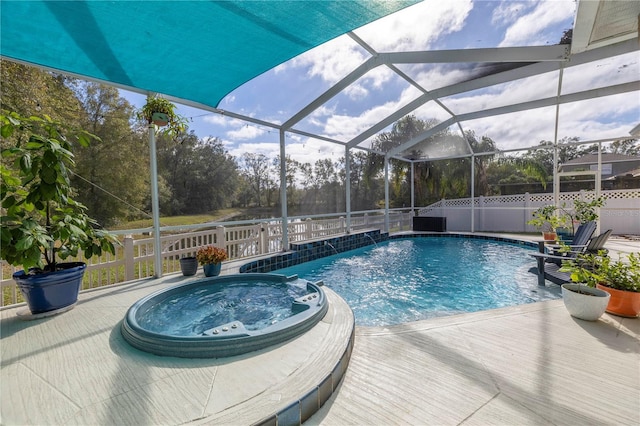 view of swimming pool featuring pool water feature, a lanai, and an in ground hot tub