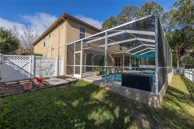 rear view of property with a fenced in pool, a lanai, and a lawn