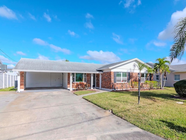 ranch-style home featuring a carport and a front yard