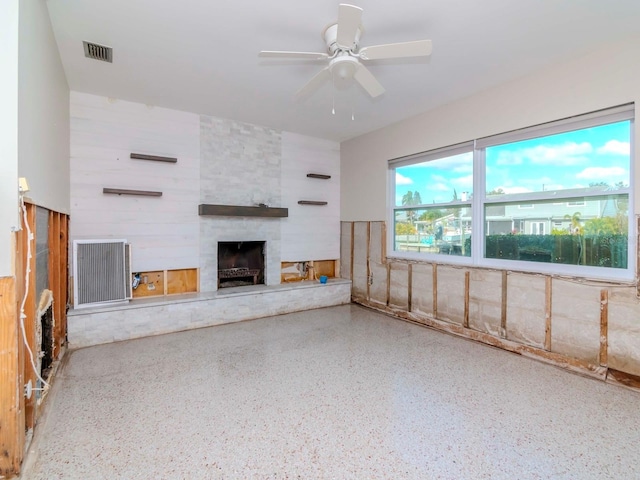 unfurnished living room featuring ceiling fan and a fireplace