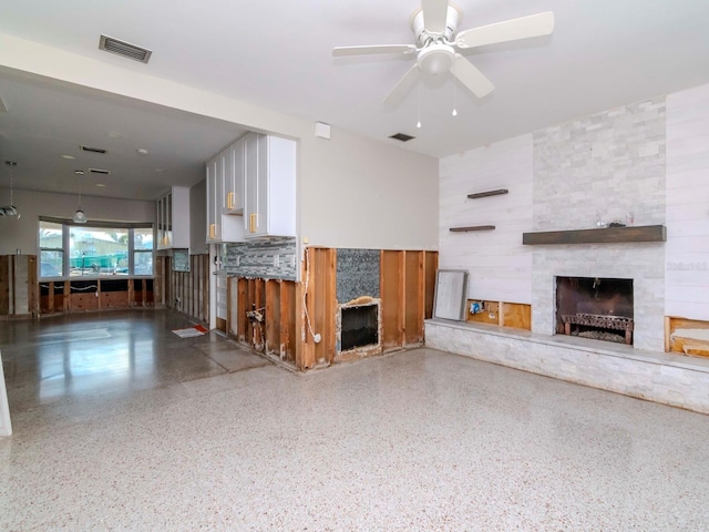 unfurnished living room featuring a fireplace and ceiling fan