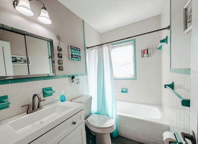 full bathroom featuring shower / bathtub combination with curtain, vanity, tile walls, and toilet