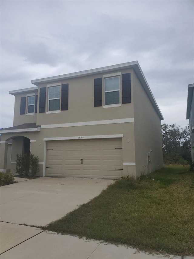 view of front of house with a front lawn and a garage