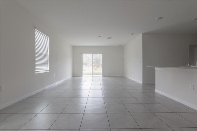 unfurnished room with light tile patterned floors