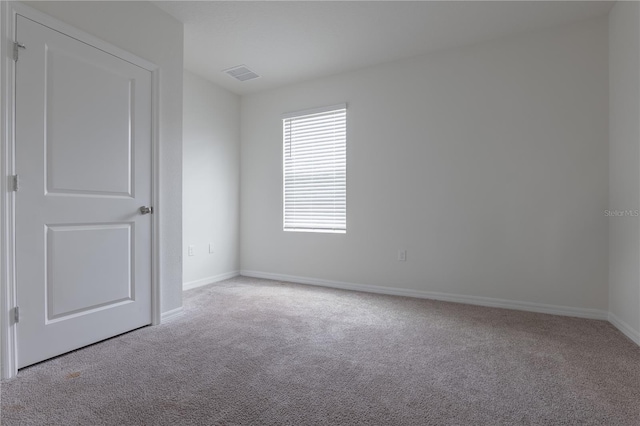 spare room with light colored carpet