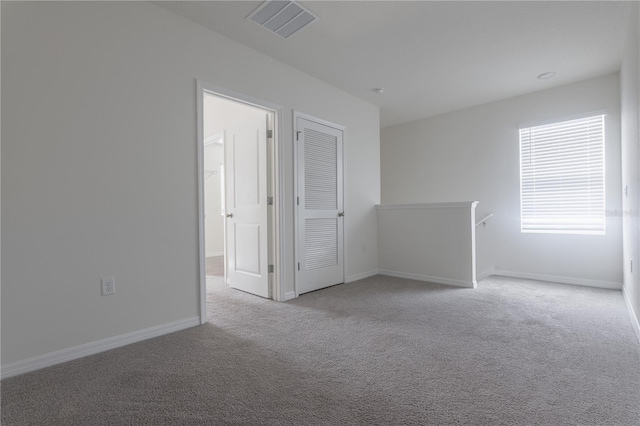 empty room featuring light colored carpet