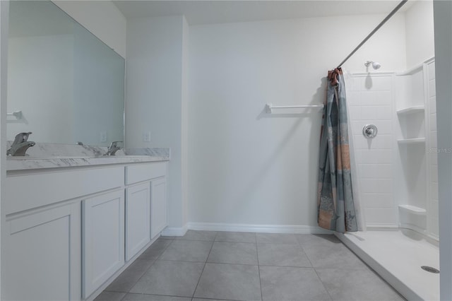 bathroom with tile patterned floors, walk in shower, and vanity