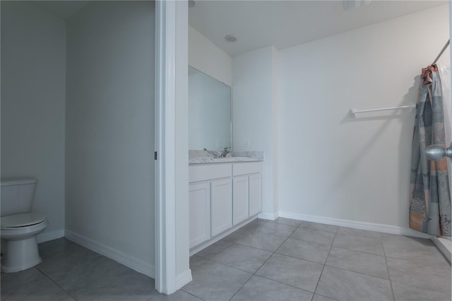 bathroom featuring tile patterned flooring, vanity, and toilet