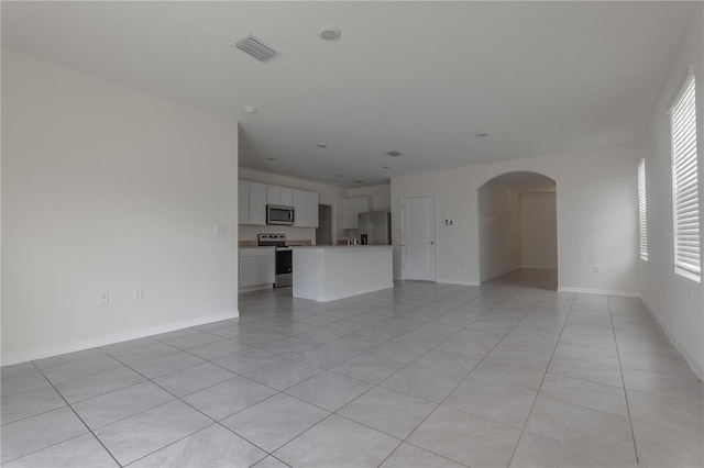 unfurnished living room featuring light tile patterned floors