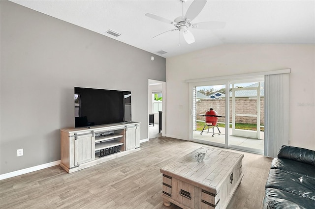 living room featuring ceiling fan, light hardwood / wood-style floors, and lofted ceiling