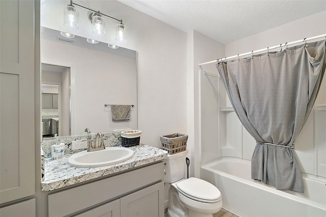 full bathroom with vanity, toilet, shower / bathtub combination with curtain, and a textured ceiling