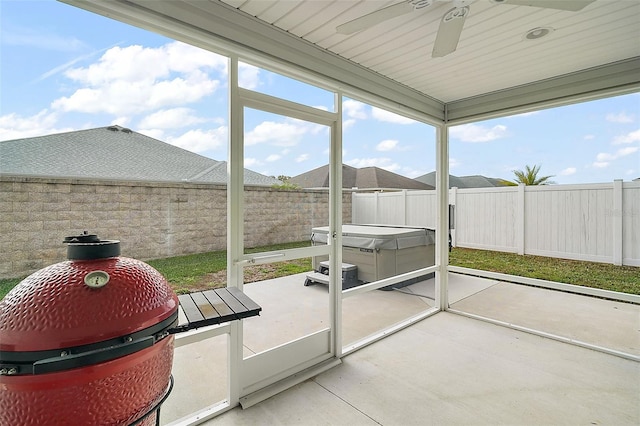 unfurnished sunroom featuring ceiling fan