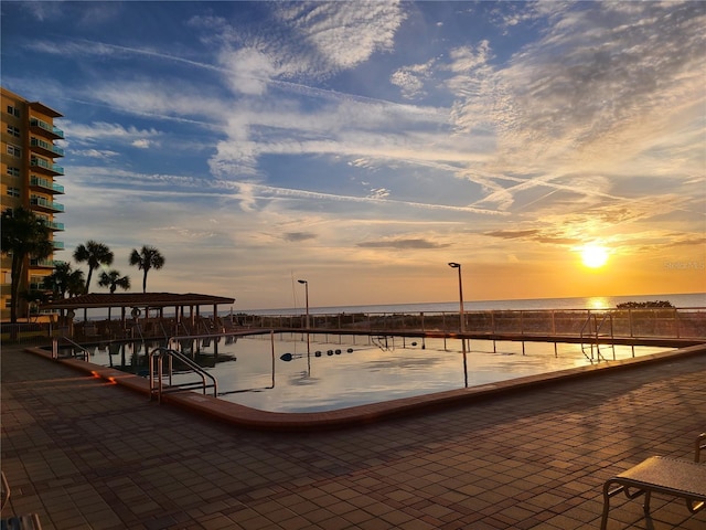 pool at dusk with a water view