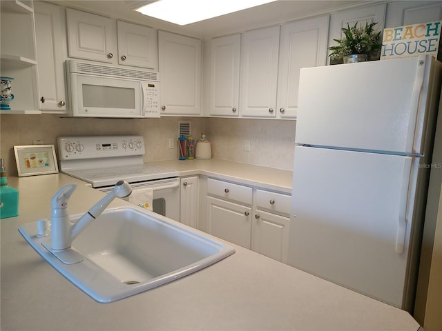 kitchen featuring white cabinets, white appliances, and sink