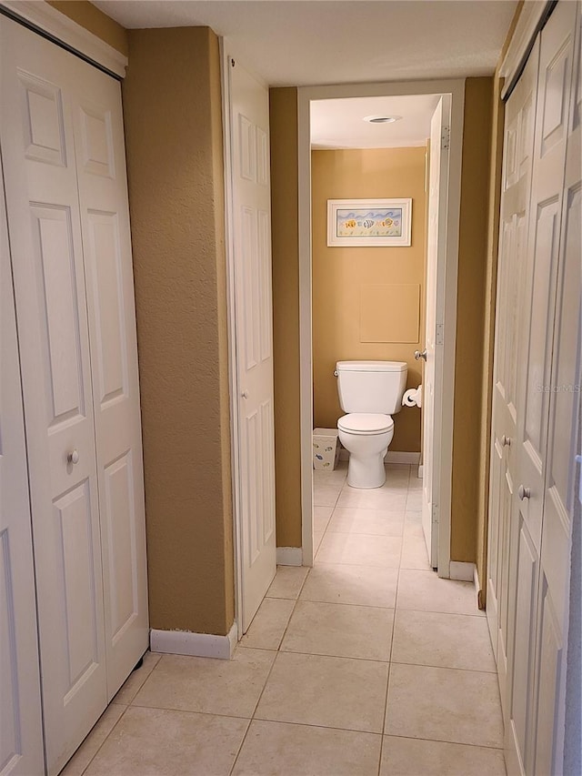 bathroom featuring tile patterned floors and toilet