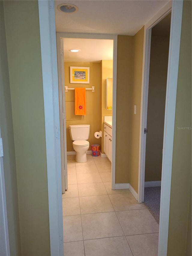 bathroom with tile patterned flooring, vanity, and toilet