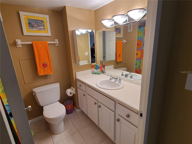 bathroom featuring tile patterned floors, vanity, and toilet