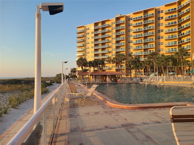 view of pool at dusk