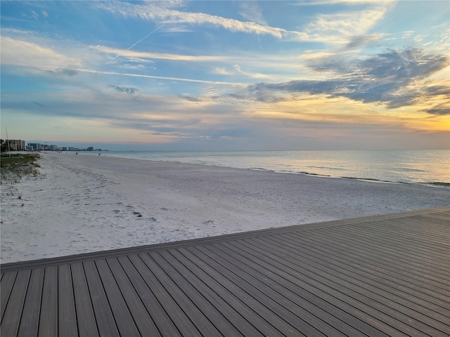 dock area with a beach view and a water view