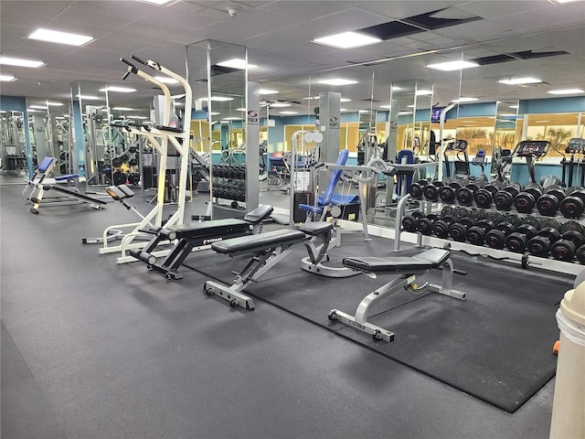 gym with a paneled ceiling