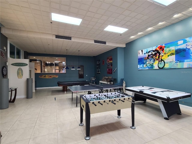 recreation room featuring tile patterned flooring and a drop ceiling