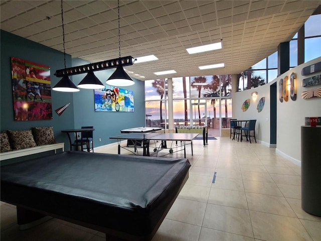 playroom with tile patterned floors, a towering ceiling, expansive windows, and billiards