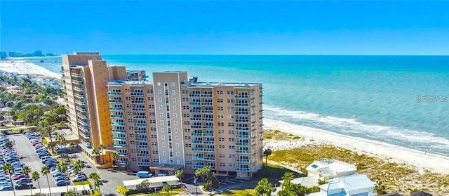 view of building exterior featuring a water view and a view of the beach