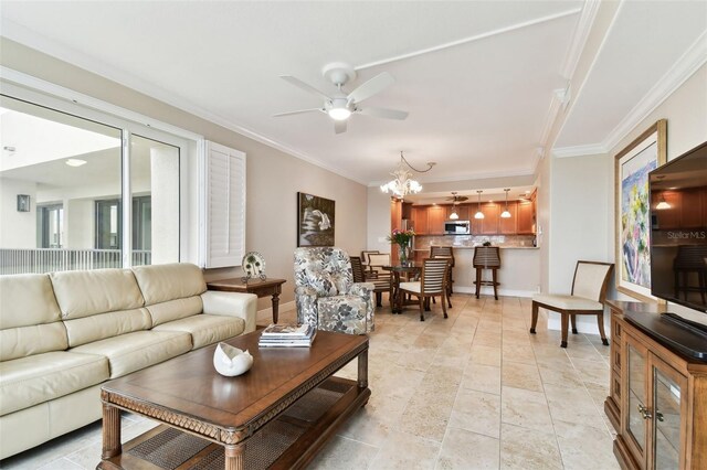 living room featuring crown molding and ceiling fan with notable chandelier