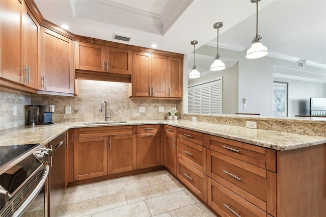 kitchen with pendant lighting, crown molding, sink, and decorative backsplash