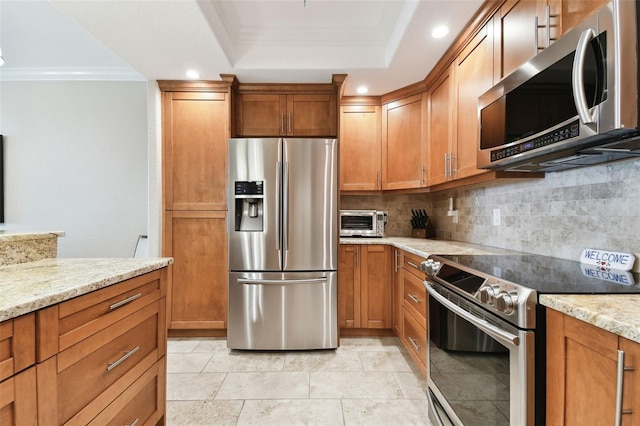 kitchen with crown molding, light stone countertops, decorative backsplash, and appliances with stainless steel finishes