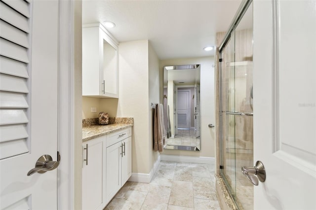 bathroom with vanity and walk in shower