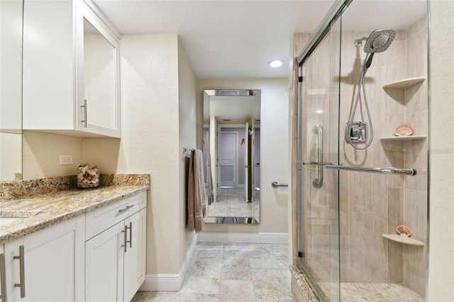 bathroom featuring vanity and an enclosed shower