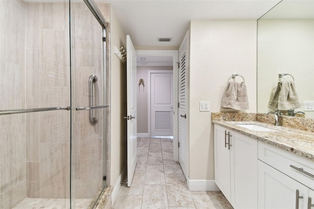 bathroom with vanity and a shower with shower door