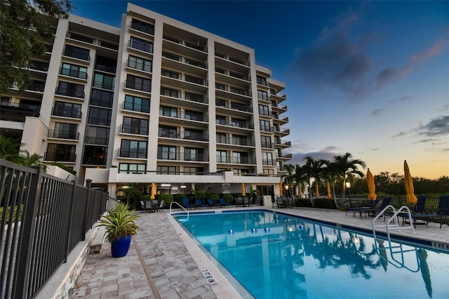 pool at dusk with a patio