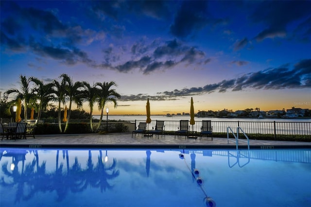 pool at dusk with a water view