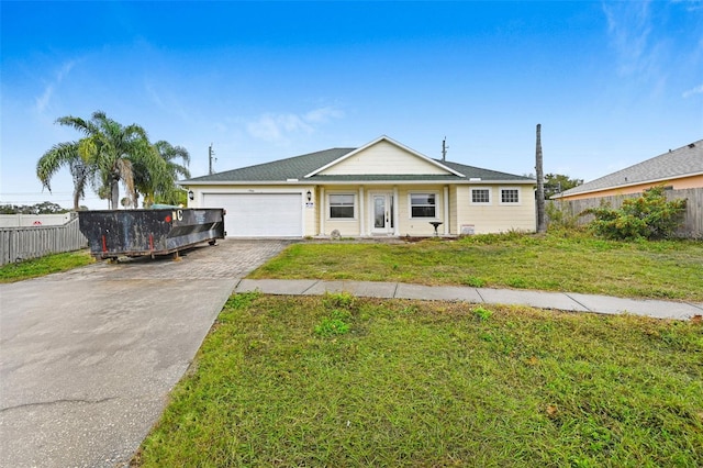 single story home with a garage and a front lawn