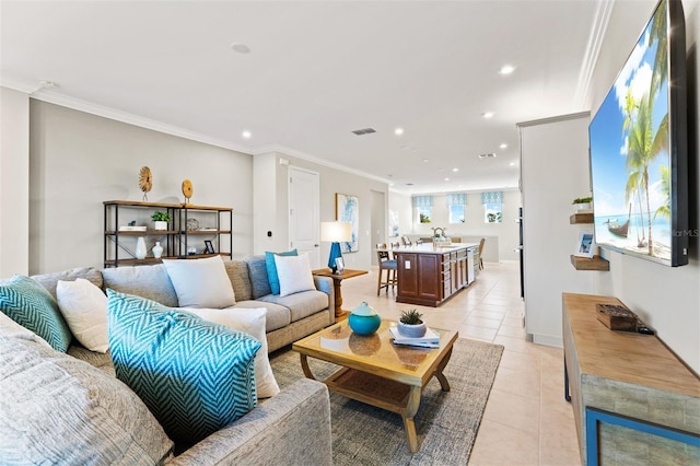 tiled living room featuring ornamental molding and sink