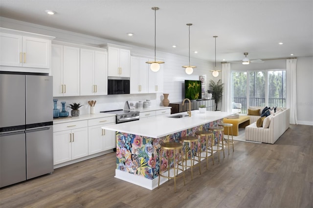 17390 Moonflower Dr Unit 202, Venice, FL 34293 - kitchen with a sink, stainless steel appliances, open floor plan, and white cabinets