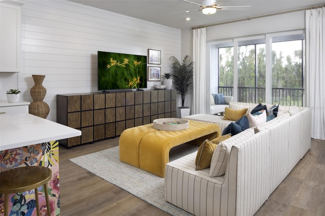 17390 Moonflower Dr Unit 202, Venice, FL 34293 - living area featuring wooden walls, a ceiling fan, and wood finished floors
