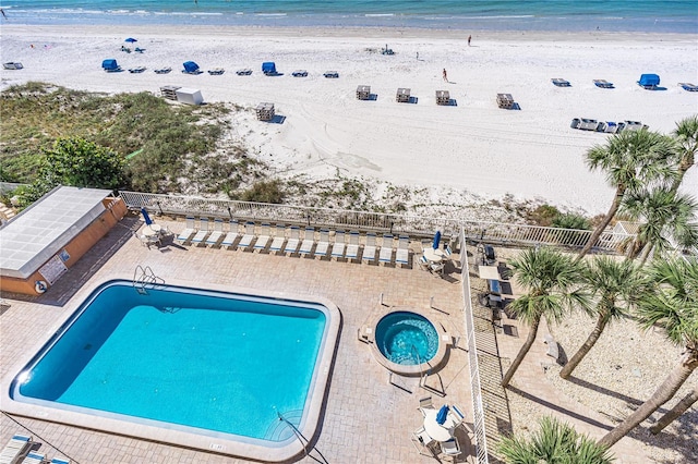 birds eye view of property with a view of the beach and a water view