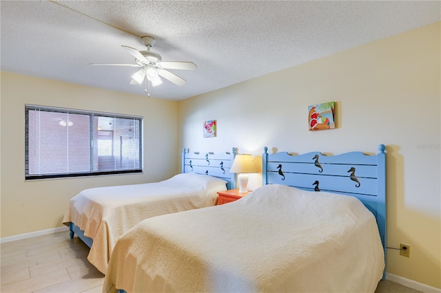 bedroom with ceiling fan and a textured ceiling