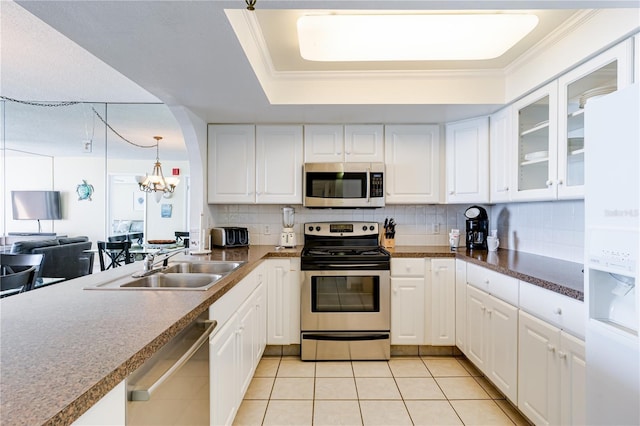 kitchen with a chandelier, white cabinetry, light tile patterned flooring, and stainless steel appliances