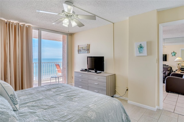 bedroom featuring multiple windows, access to outside, ceiling fan, and floor to ceiling windows