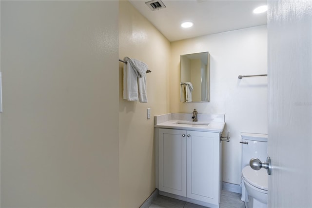 bathroom featuring tile patterned flooring, vanity, and toilet