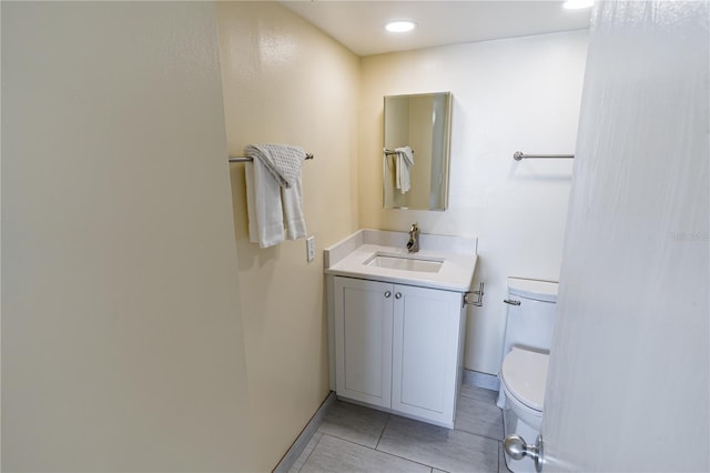 bathroom featuring tile patterned floors, vanity, and toilet